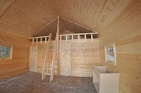 Inside the La Casa cabin kit showing the finished wood ceiling and cabin ready to have the kitchen installed